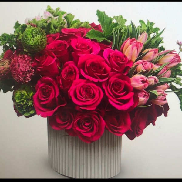 Bouquet of hot pink roses and pink tulips in a ribbed white vase
