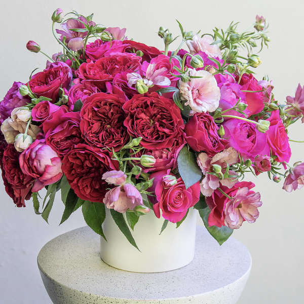 Pink and red rose bouquet in a white vase