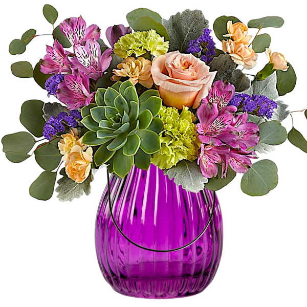 Mixed bouquet in a purple glass vase with a succulent centerpiece