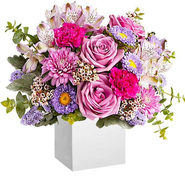 Pink and lavender mixed bouquet in a white box vase