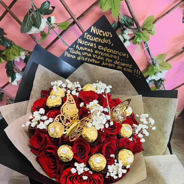 Bouquet of red roses with gold-wrapped chocolates and white baby's breath
