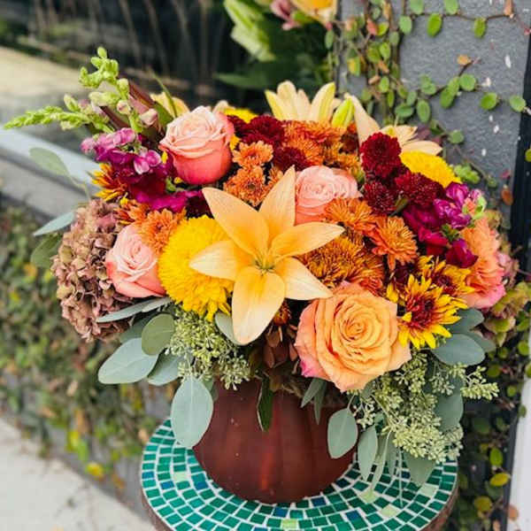 Mixed bouquet of roses, lilies, and chrysanthemums in a vase