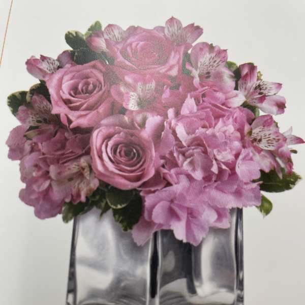 Pink roses and alstroemeria in a clear square vase