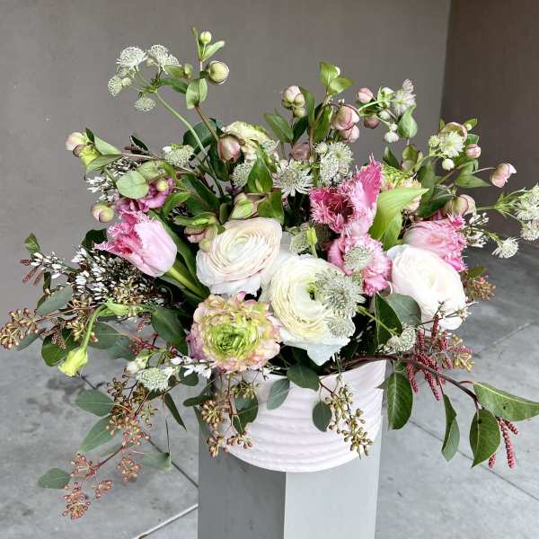 Pink and white mixed flower arrangement in a white vase