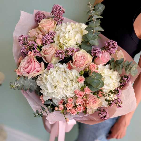 Bouquet of pink roses, white hydrangeas, and purple filler flowers