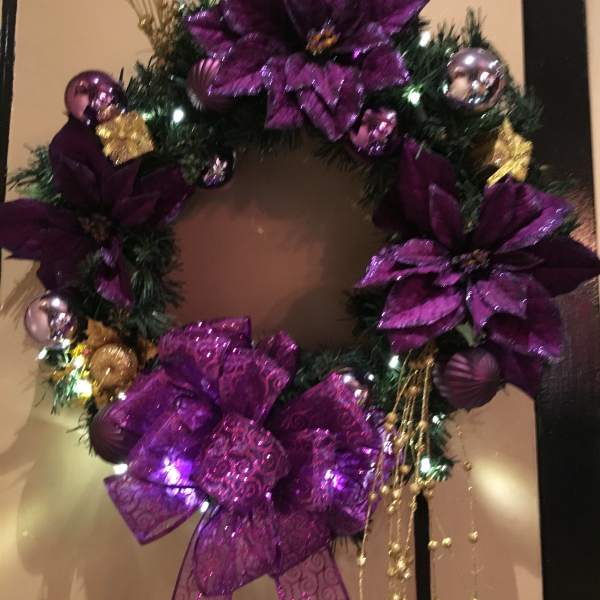 Purple decorated wreath with bows and ornaments