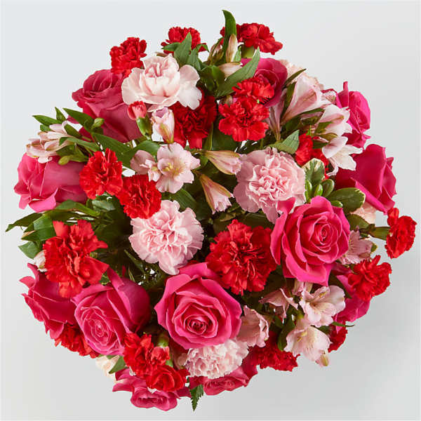 Round bouquet of pink and red roses with carnations and alstroemeria