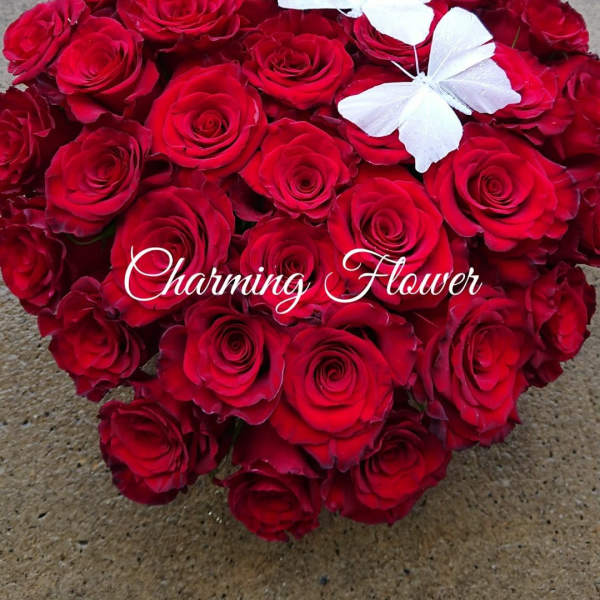 Heart-shaped bouquet of red roses with two white butterflies