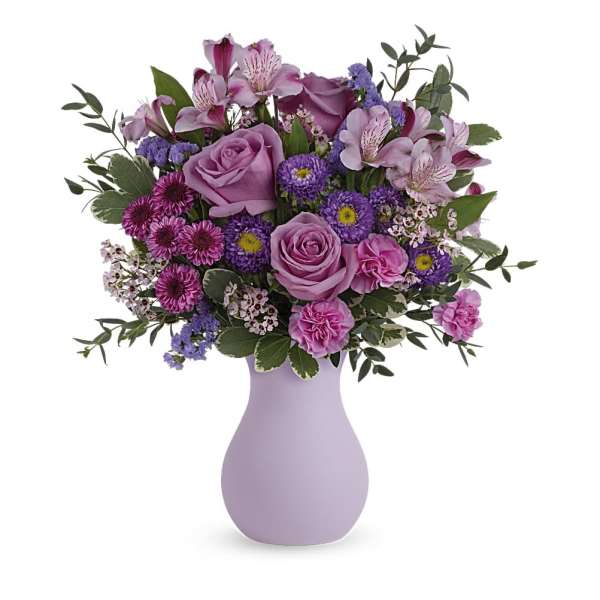 Pink and purple mixed bouquet in a lavender vase