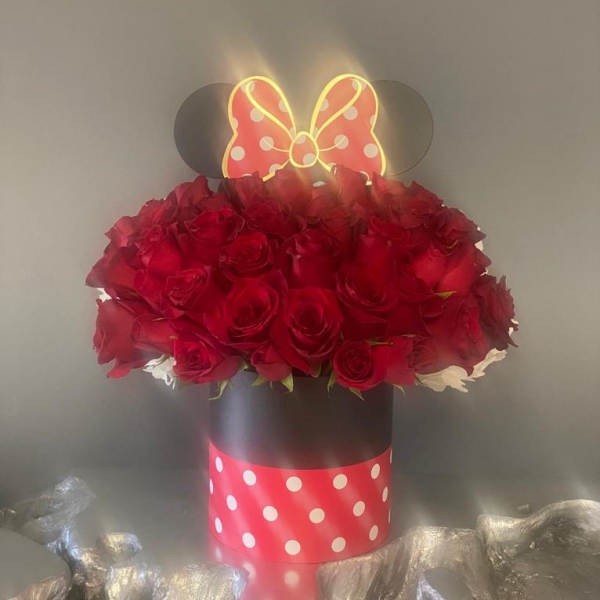 Red roses in a black hatbox with a Minnie Mouse bow topper
