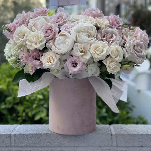 Pink and white rose bouquet in a blush cylindrical box