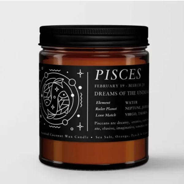 Amber jar candle with a black Pisces label