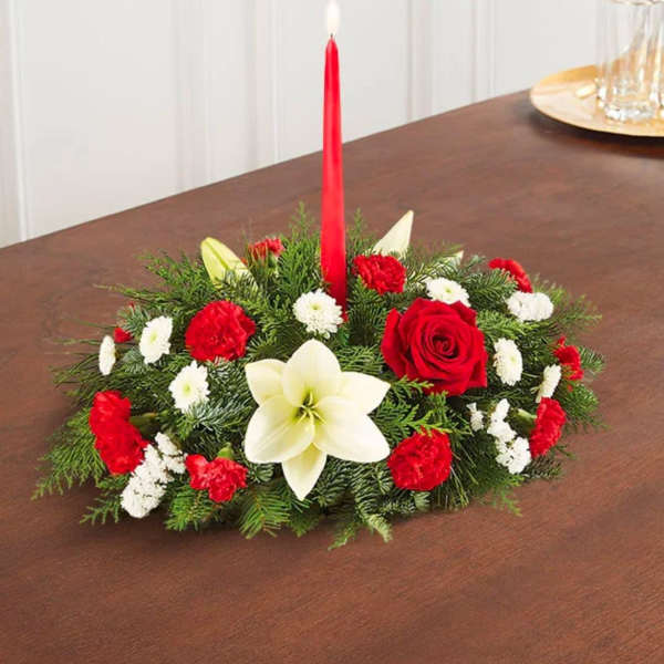 Low floral centerpiece with a red taper candle and red, white blooms