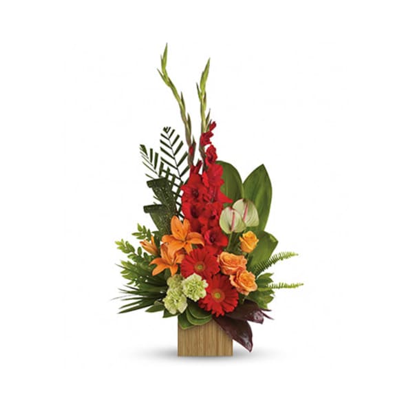 Tall tropical arrangement with red, orange, and green flowers in a wooden container