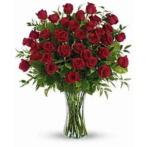 Red roses arranged in a clear glass vase