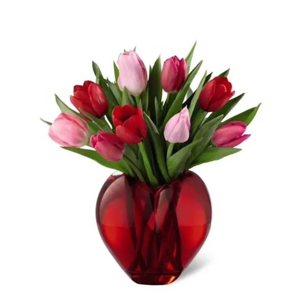 Pink and red tulips in a red heart-shaped vase