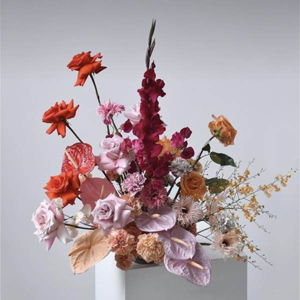 Tall mixed bouquet with orange, pink, and burgundy flowers