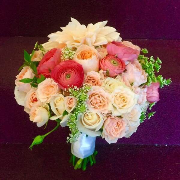 Bouquet of blush and cream flowers with a white wrap