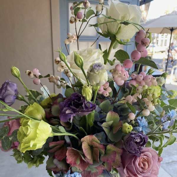 Mixed bouquet with roses, lisianthus, hydrangea, and berry stems