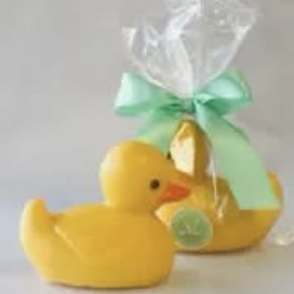 Yellow duck-shaped gift item wrapped in clear cellophane with a mint ribbon