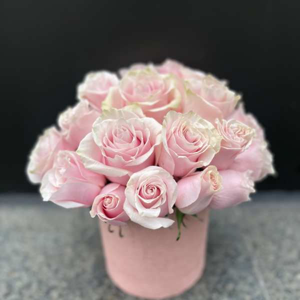 Pink roses arranged in a blush pink box