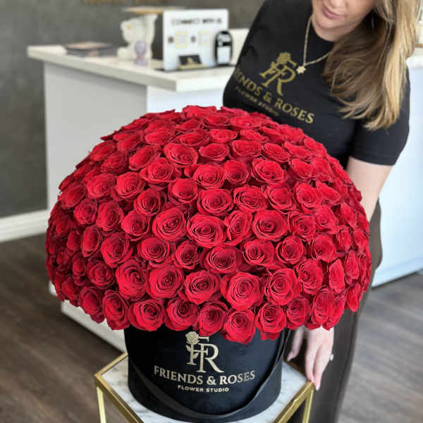 Large dome of red roses in a black hatbox
