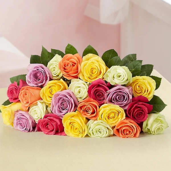 A bouquet of multicolored roses with dark green leaves.
