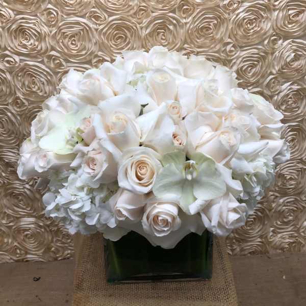 White rose bouquet in a square glass vase