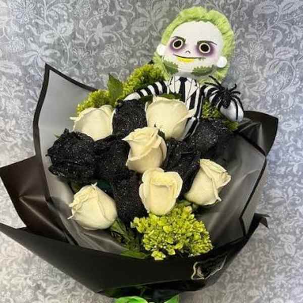 Bouquet of white roses with a small plush character topper