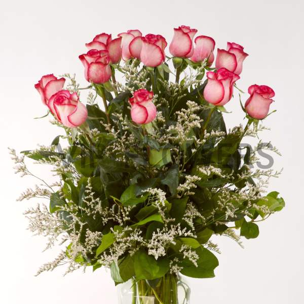 Pink roses arranged in a clear glass vase