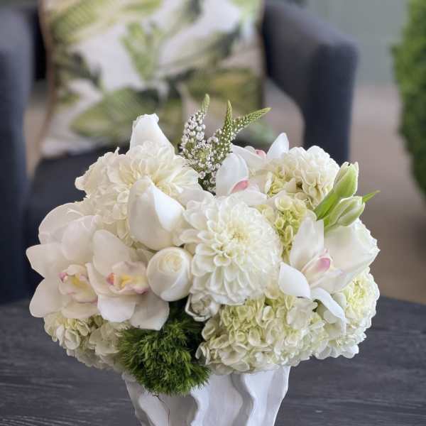 White floral arrangement in a sculpted white vase