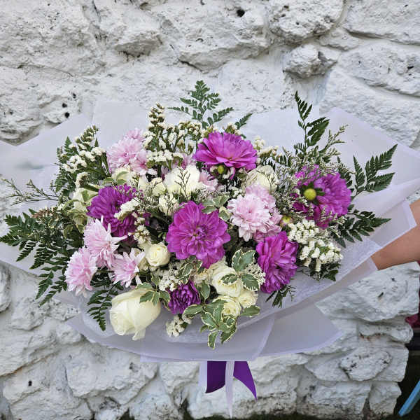 Hand-tied bouquet of pink and purple flowers with white roses
