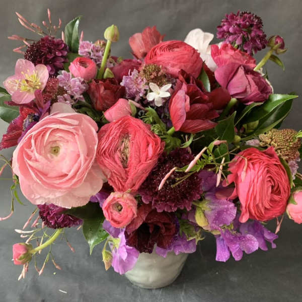 Mixed pink and purple bouquet in a white vase