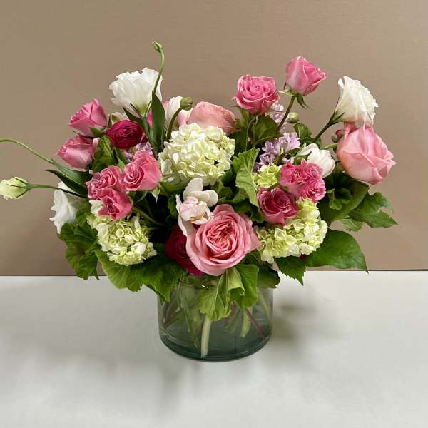 Pink and white rose bouquet in a glass vase