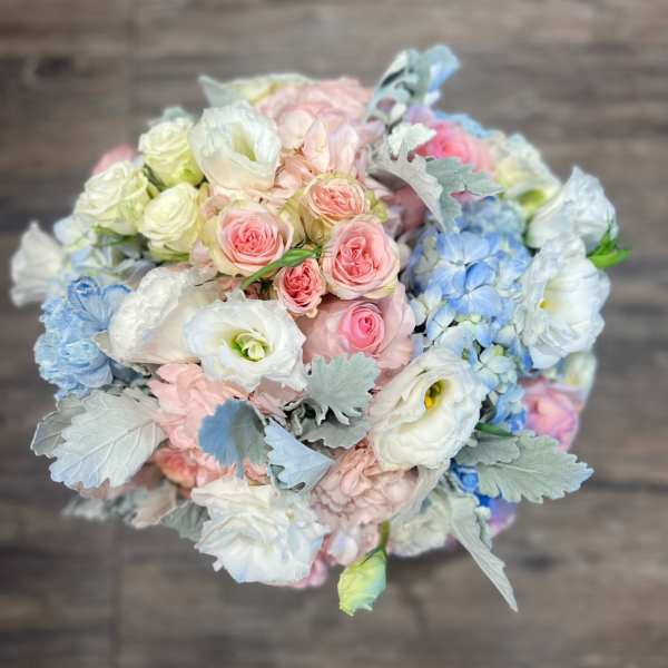 Pastel bouquet of roses and white blooms with silvery foliage