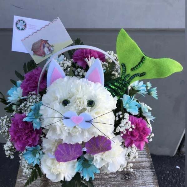 Cat-shaped floral arrangement with a green felt tail and ears