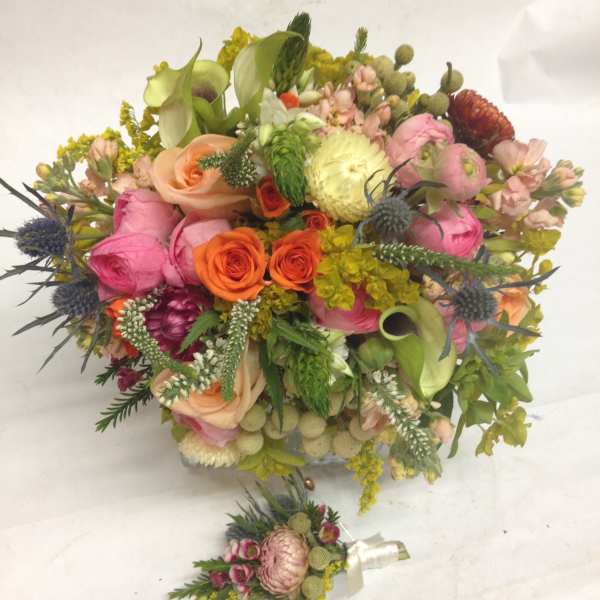 Colorful mixed bouquet with roses, calla lilies, and thistle