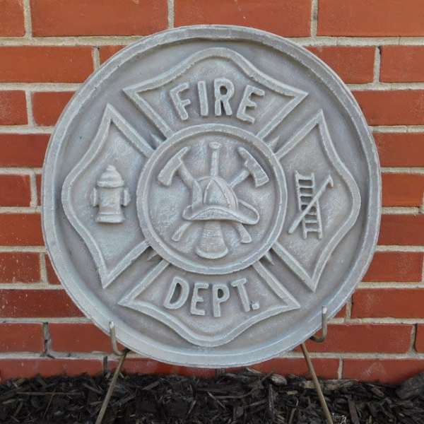 Fire department emblem plaque mounted on a brick wall
