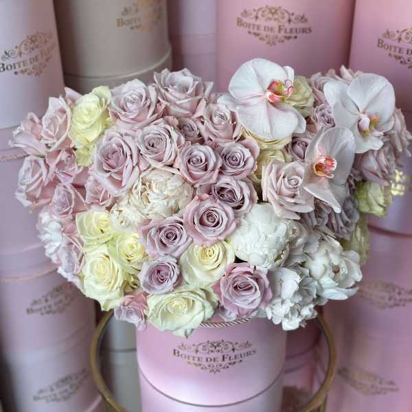 Pastel rose bouquet in a pink hat box with white orchids