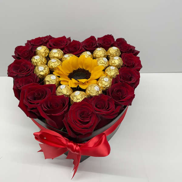 Heart-shaped box of red roses with a sunflower and gold chocolates