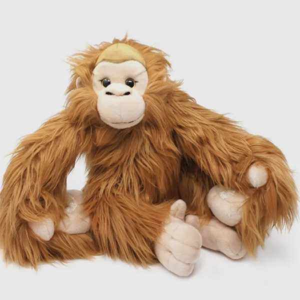 Plush orangutan toy sitting on a white background