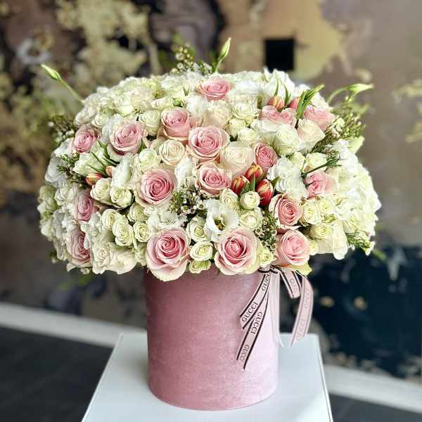 Pink and white rose bouquet in a pink hat box with ribbon