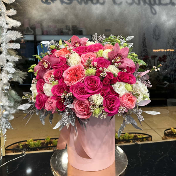Pink and coral rose arrangement in a blush cylindrical box