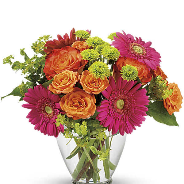 Bouquet of orange roses and pink gerbera daisies in a clear glass vase