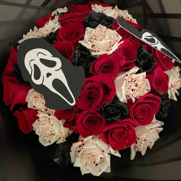 Bouquet of red, white, and black roses with Ghostface toppers
