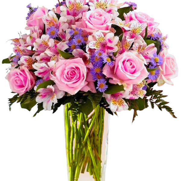 Pink roses and mixed purple flowers in a clear glass vase