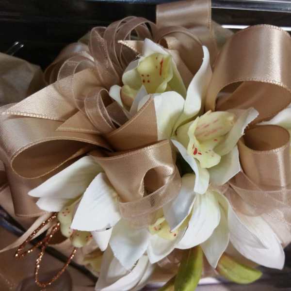 Bouquet of white orchids wrapped with tan ribbon