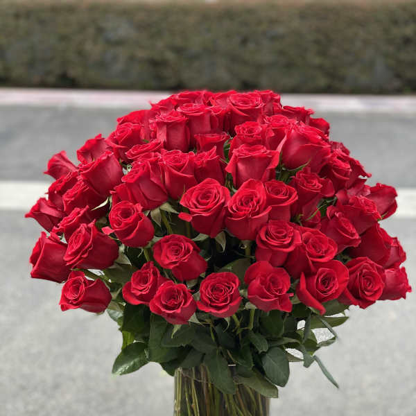 Large bouquet of red roses in a clear glass vase