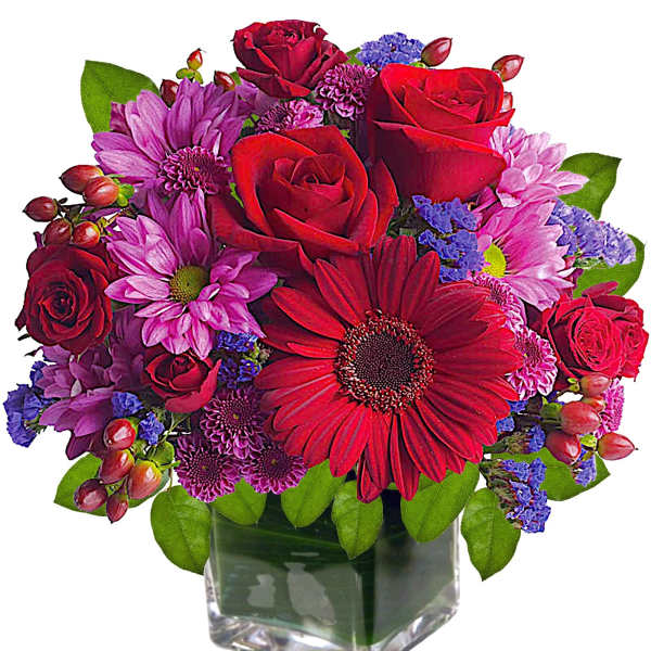 Mixed bouquet of red roses and pink daisies in a glass vase