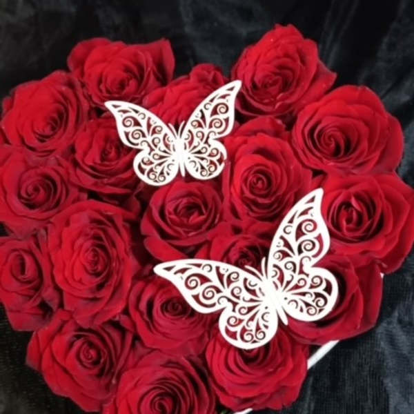 Heart-shaped bouquet of red roses with white butterfly decorations